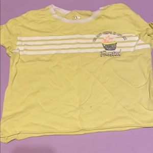 white striped yellow shirt. Cupcake on side